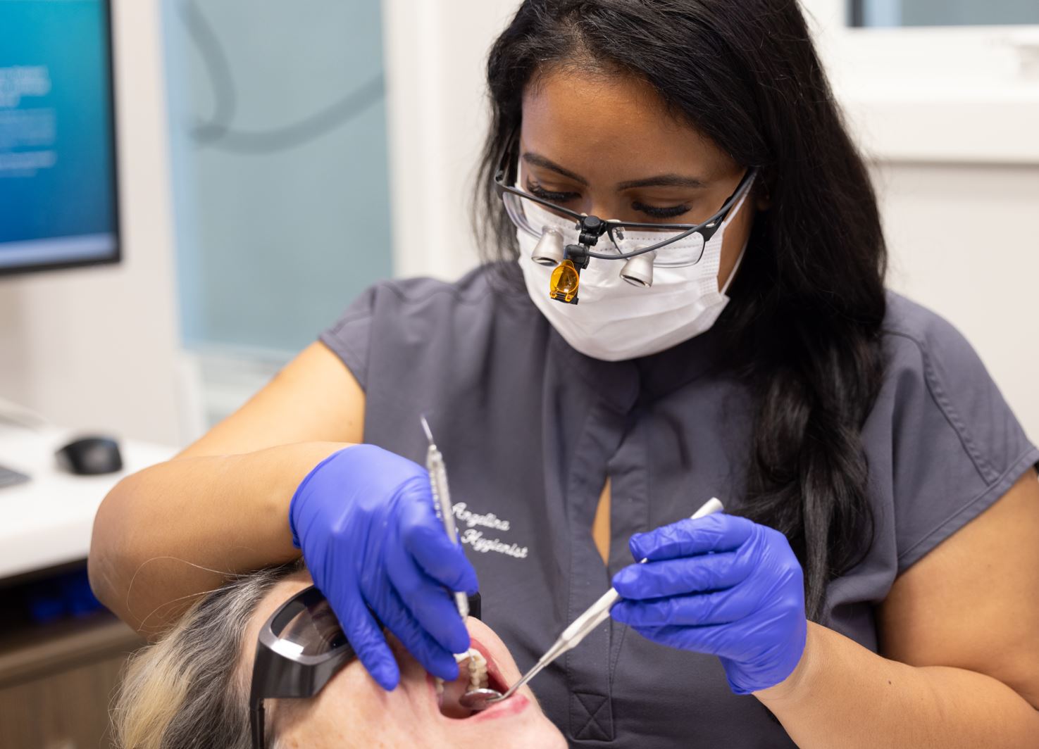 Dental Hygienists examines patient 